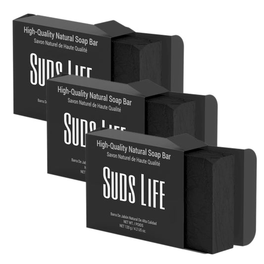 Three bars of black natural charcoal soap from suds life on a white background.